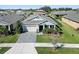 Beautifully landscaped front yard leading to a well-maintained two story home at 6232 Sea Air Dr, Apollo Beach, FL 33572