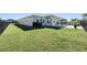 Expansive grassy backyard with a covered patio, perfect for entertaining at 6232 Sea Air Dr, Apollo Beach, FL 33572