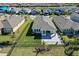 A well manicured backyard featuring lush green grass, a paver patio, and secure metal fencing at 6232 Sea Air Dr, Apollo Beach, FL 33572
