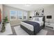 Cozy bedroom with a king-sized bed, soft linens, and three windows providing natural light and neighborhood views at 6232 Sea Air Dr, Apollo Beach, FL 33572