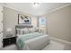 Comfortable bedroom featuring a queen bed, soft lighting, and neutral colors for a restful and inviting atmosphere at 6232 Sea Air Dr, Apollo Beach, FL 33572