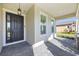 Beautiful front entrance with sidelight windows and pavers with decorative stone pillars, for a welcoming appeal at 6232 Sea Air Dr, Apollo Beach, FL 33572