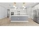 Modern open kitchen with white cabinets, stainless steel appliances, and a large central island at 6232 Sea Air Dr, Apollo Beach, FL 33572