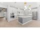Bright, open kitchen with white cabinets, stainless steel appliances, and a spacious island for entertaining at 6232 Sea Air Dr, Apollo Beach, FL 33572