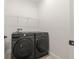 Bright laundry room with black Samsung washer and dryer, and convenient wire shelving above at 6232 Sea Air Dr, Apollo Beach, FL 33572
