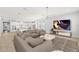 Bright and airy living room featuring modern decor, sleek furniture, and an open-concept design to the kitchen at 6232 Sea Air Dr, Apollo Beach, FL 33572