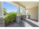 Covered porch with stone base pillars and pavers, surrounded by lush landscaping at 6232 Sea Air Dr, Apollo Beach, FL 33572
