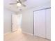 Cozy bedroom features a ceiling fan, wood-look floors, and a closet at 6699 78Th N Ave, Pinellas Park, FL 33781