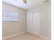 Bedroom with closet, neutral walls, wood-look floors, and a ceiling fan at 6699 78Th N Ave, Pinellas Park, FL 33781