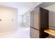 Kitchen features a stainless steel four door refrigerator and light filled adjoining room at 6699 78Th N Ave, Pinellas Park, FL 33781