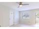 Living room with fan, natural light from the window, and entrance to sunroom at 6699 78Th N Ave, Pinellas Park, FL 33781