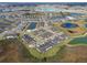 Aerial view showcases the community with multiple ponds and lush landscaping throughout the neighborhood at 10374 Echo Dock Loop, San Antonio, FL 33576