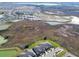 Wide aerial view of the community featuring new construction, ponds, and undeveloped natural areas at 10374 Echo Dock Loop, San Antonio, FL 33576