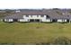 Aerial view of the home with a large, green backyard and views of the well-maintained community at 10374 Echo Dock Loop, San Antonio, FL 33576