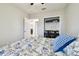 Bedroom with open closet and desk, featuring blue accents and a view into the hallway at 10374 Echo Dock Loop, San Antonio, FL 33576