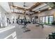 Spacious gym featuring modern equipment, ceiling fans, ample lighting, and multiple windows at 10374 Echo Dock Loop, San Antonio, FL 33576