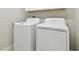 Functional laundry room featuring a side-by-side washer and dryer set for convenient home chores at 10374 Echo Dock Loop, San Antonio, FL 33576