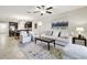 Open living room and kitchen layout with comfortable seating, area rug, and modern ceiling fan at 10374 Echo Dock Loop, San Antonio, FL 33576