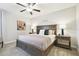 Primary bedroom featuring a wooden bed frame, ceiling fan, and bedside tables with lamps at 10374 Echo Dock Loop, San Antonio, FL 33576