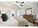 Well-lit Primary bedroom with a wooden dresser and view of en suite bathroom and additional rooms at 10374 Echo Dock Loop, San Antonio, FL 33576