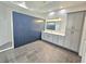 Modern bathroom features gray vanity, a walk-in shower, and wainscotting providing a spa-like experience at 11199 Warm Wind Way, Weeki Wachee, FL 34613