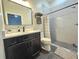 Bathroom featuring modern vanity with dark wood cabinets and a tiled shower with gray accents at 11199 Warm Wind Way, Weeki Wachee, FL 34613