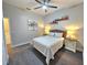 Bright bedroom featuring a woven headboard, side tables and ceiling fan at 11199 Warm Wind Way, Weeki Wachee, FL 34613