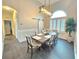 Elegant dining room featuring a modern light fixture, wainscoting, and a sliding barn door at 11199 Warm Wind Way, Weeki Wachee, FL 34613