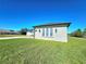 Exterior of a stucco home showing the front elevation with well-manicured lawn at 11199 Warm Wind Way, Weeki Wachee, FL 34613
