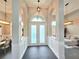 Welcoming foyer with a view into the dining and living areas, enhanced by stylish lighting at 11199 Warm Wind Way, Weeki Wachee, FL 34613