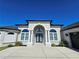 Beautiful home with arched entryway, decorative columns, and meticulously maintained landscaping at 11199 Warm Wind Way, Weeki Wachee, FL 34613
