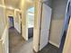 Hallway with white wainscotting and doors that lead to bathrooms and bedrooms in the home at 11199 Warm Wind Way, Weeki Wachee, FL 34613