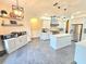 The kitchen has a center island, stainless steel appliances, and stylish white cabinets at 11199 Warm Wind Way, Weeki Wachee, FL 34613