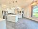 Spacious kitchen with large center island, white cabinets, modern lighting, and stainless steel appliances at 11199 Warm Wind Way, Weeki Wachee, FL 34613