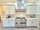 The kitchen has stainless steel appliances, white cabinets, and stylish backsplash at 11199 Warm Wind Way, Weeki Wachee, FL 34613