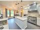 Open kitchen with a center island, stainless appliances, and stylish cabinets at 11199 Warm Wind Way, Weeki Wachee, FL 34613