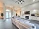 The living room has high ceilings, a fireplace, patio doors, and lots of natural light at 11199 Warm Wind Way, Weeki Wachee, FL 34613