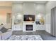 Bright living room featuring a fireplace, built-in cabinets, and a large flat-screen TV at 11199 Warm Wind Way, Weeki Wachee, FL 34613