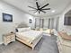 Spacious main bedroom with modern ceiling fan, night stands, and large windows providing lots of natural light at 11199 Warm Wind Way, Weeki Wachee, FL 34613