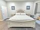 Large main bedroom features a bed with a decorative headboard, soft bedding, and artwork providing a comfortable space at 11199 Warm Wind Way, Weeki Wachee, FL 34613