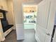 Walk-in pantry with white shelving and storage, conveniently located near a mudroom with a bench at 11199 Warm Wind Way, Weeki Wachee, FL 34613