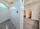 Modern shower features white tile, a showerhead with ambient light, and a tiled floor providing a spa-like experience at 11199 Warm Wind Way, Weeki Wachee, FL 34613