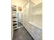 Custom walk-in closet with mirror and organized shelving, providing optimal storage space at 11199 Warm Wind Way, Weeki Wachee, FL 34613