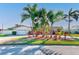 Charming single-story home featuring lush landscaping and mature palm trees enhancing curb appeal at 1575 Brookside Blvd, Largo, FL 33770