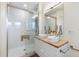 Modern bathroom featuring a sleek vanity with dual vessel sinks, walk-in shower, and neutral tile at 2201 Park N St, St Petersburg, FL 33710