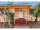 Inviting entrance featuring a decorative door, well-manicured landscaping, and tropical accents at 2201 Park N St, St Petersburg, FL 33710