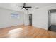 Bright bedroom featuring hardwood floors, a ceiling fan, and a window for natural light at 6327 2Nd S Ave, St Petersburg, FL 33707