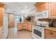 Kitchen featuring updated appliances, cabinetry, and a kitchen island at 6327 2Nd S Ave, St Petersburg, FL 33707