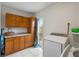 Functional laundry room with ample cabinet space, granite counters, and modern appliances at 6327 2Nd S Ave, St Petersburg, FL 33707