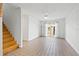 Bright living room with a staircase, tile flooring, and sliding glass doors to the outside at 6327 2Nd S Ave, St Petersburg, FL 33707